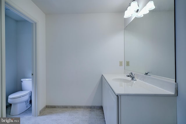 bathroom with tile patterned flooring, vanity, and toilet