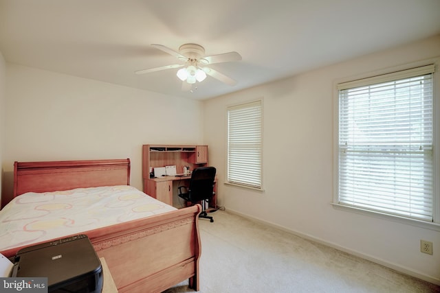 bedroom featuring ceiling fan and light colored carpet