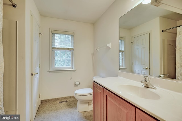 bathroom featuring curtained shower, toilet, tile patterned floors, and vanity