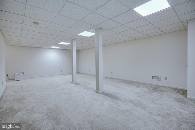 basement with light carpet and a drop ceiling