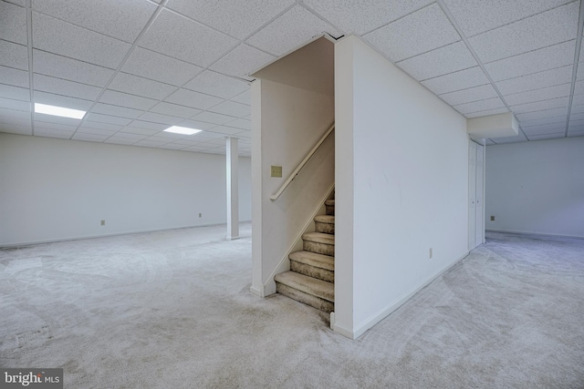 basement featuring carpet and a paneled ceiling