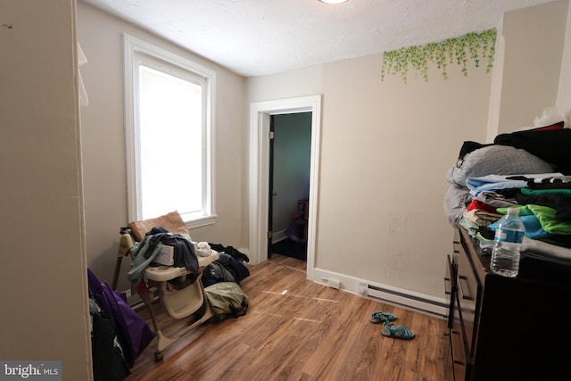 interior space with a textured ceiling and hardwood / wood-style floors