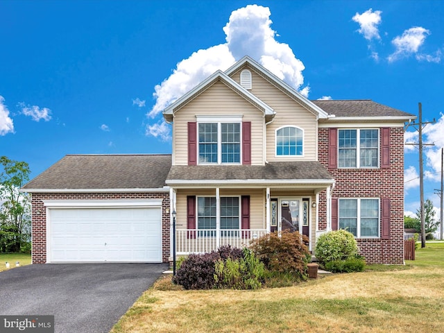 view of front of home featuring aphalt driveway, a garage, brick siding, roof with shingles, and a front lawn