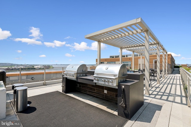 view of patio / terrace with exterior kitchen, area for grilling, and a pergola