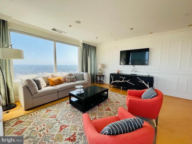 living room featuring crown molding and hardwood / wood-style flooring