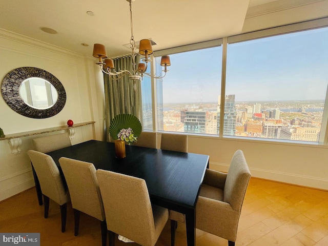 dining area featuring ornamental molding and a notable chandelier