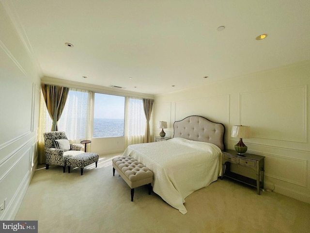 carpeted bedroom featuring a water view