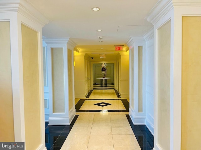 hallway featuring ornamental molding and tile patterned floors