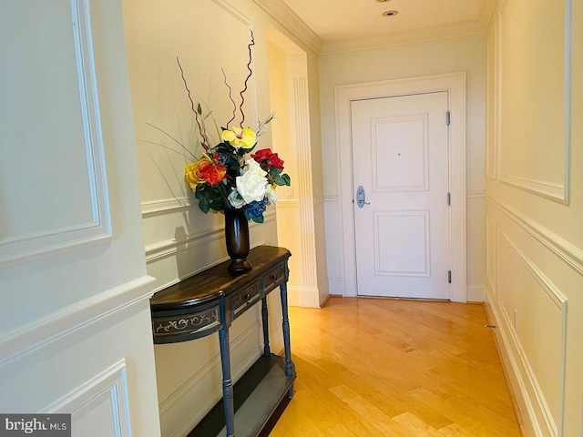 interior space featuring light wood-type flooring and crown molding