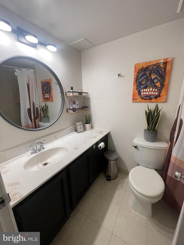 bathroom featuring toilet, tile patterned flooring, and vanity