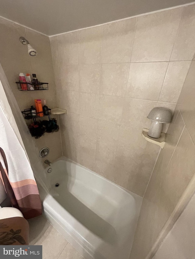 full bathroom featuring tile patterned flooring and bathtub / shower combination