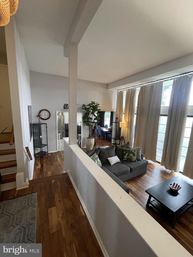 living room with stairway and wood finished floors