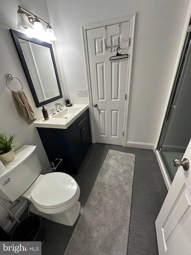 bathroom with tile patterned flooring, vanity, and toilet