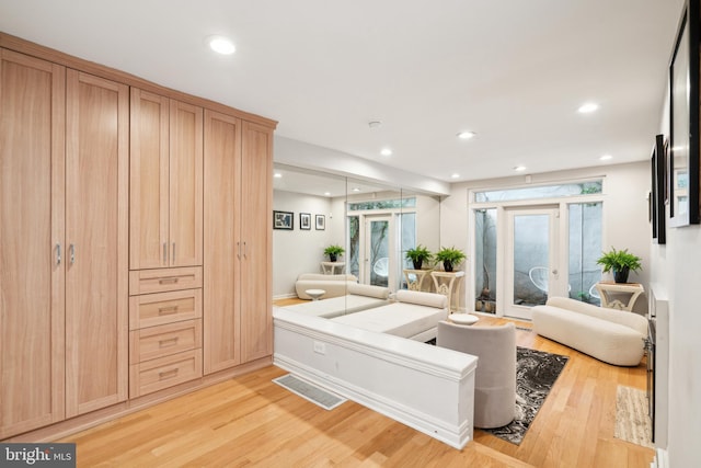 bathroom with wood-type flooring and french doors