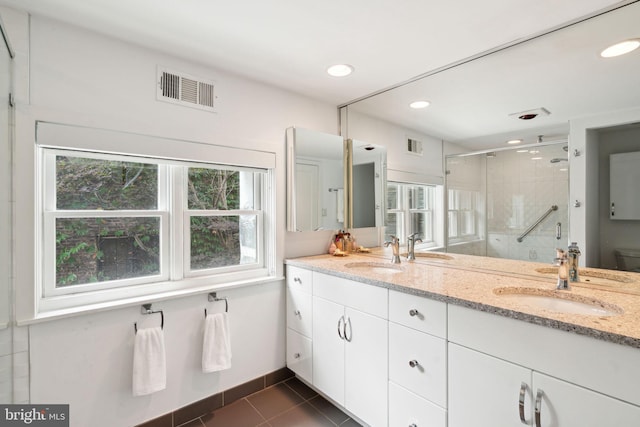 bathroom with vanity, toilet, tile patterned floors, and an enclosed shower