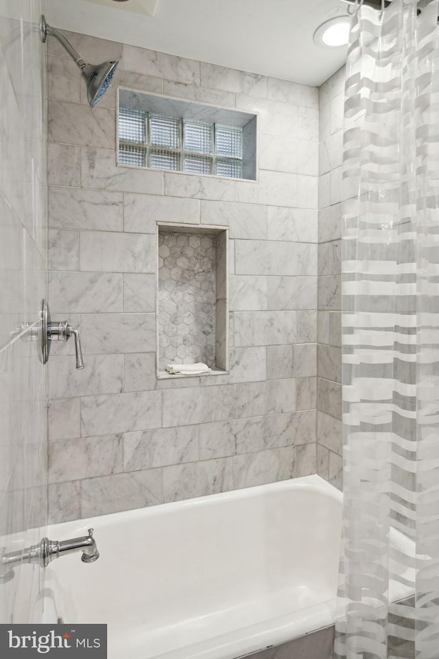 bathroom with shower / bath combination with curtain