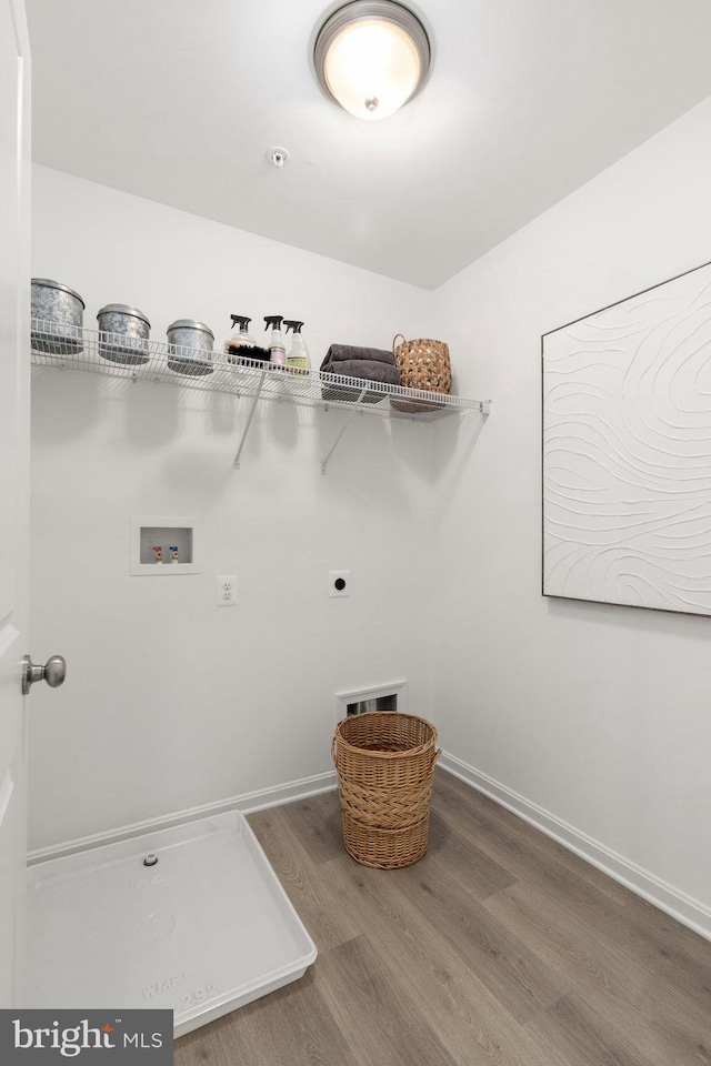 laundry room featuring hookup for an electric dryer, hookup for a washing machine, and wood-type flooring