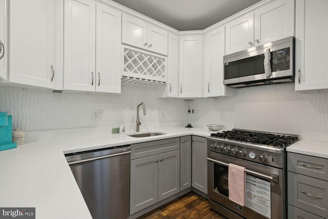 kitchen featuring sink, white cabinets, appliances with stainless steel finishes, and gray cabinets