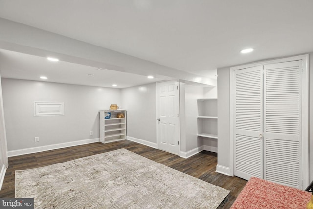 basement featuring dark hardwood / wood-style flooring