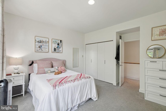 carpeted bedroom with a closet