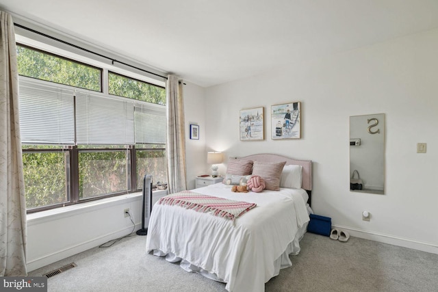 carpeted bedroom featuring multiple windows