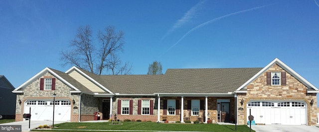 craftsman house with a garage and a front lawn