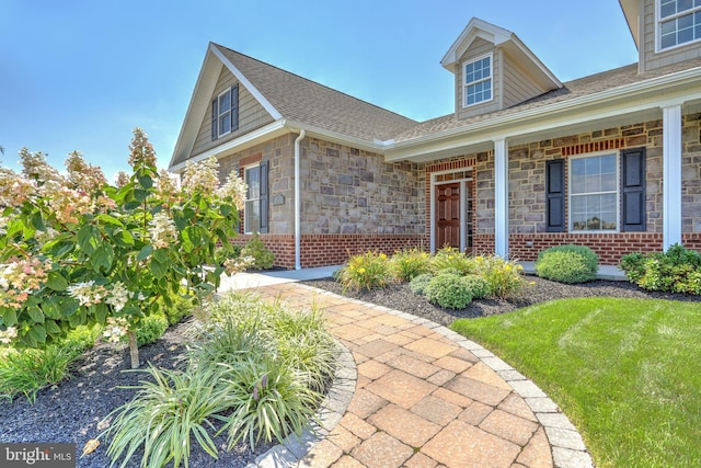 view of exterior entry with a yard