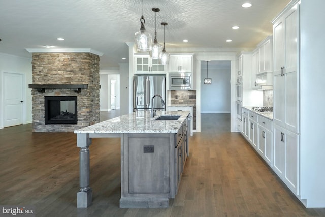 kitchen featuring sink, stainless steel appliances, dark hardwood / wood-style flooring, and white cabinets