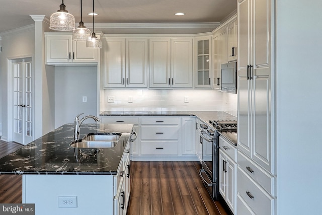 kitchen featuring sink, dark hardwood / wood-style floors, a kitchen island, white cabinetry, and range with gas cooktop