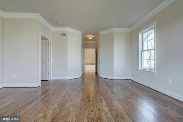 unfurnished room with hardwood / wood-style floors and crown molding