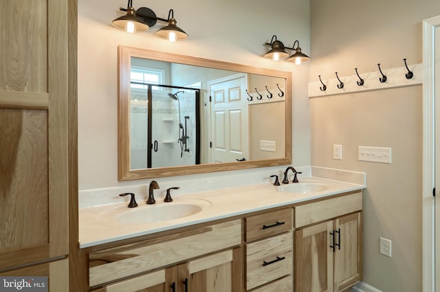 bathroom featuring double vanity and a shower with door