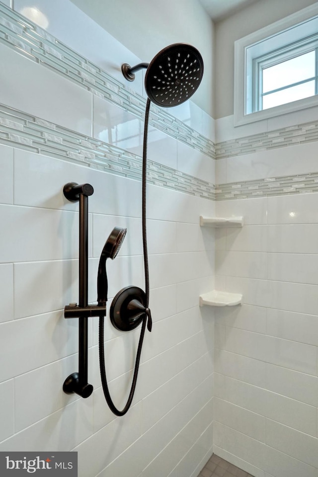 bathroom with a tile shower