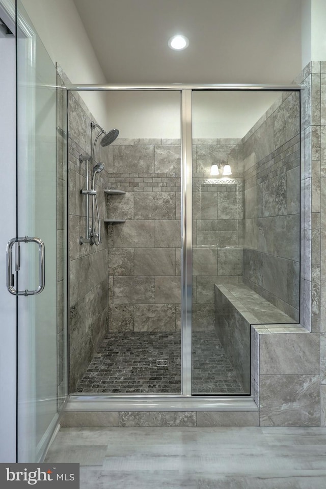 bathroom featuring a shower with shower door