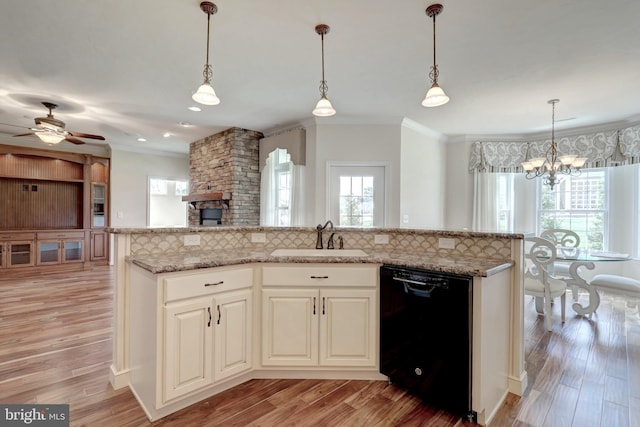 kitchen featuring sink, decorative light fixtures, decorative backsplash, and dishwasher