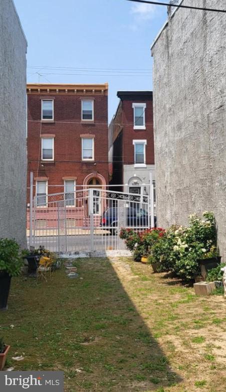 rear view of property with a lawn