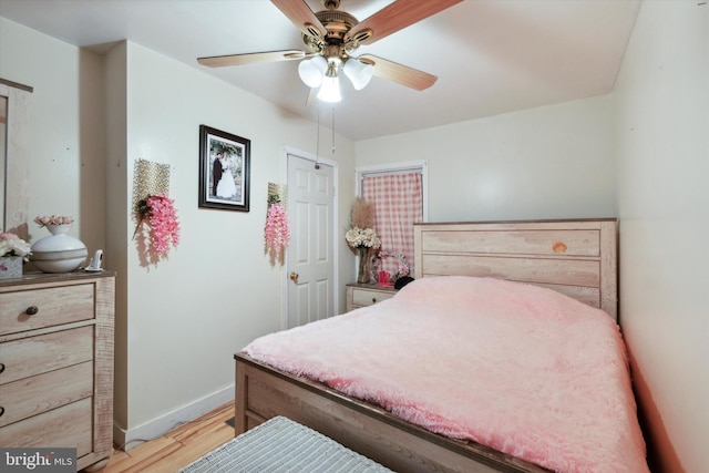 bedroom with ceiling fan and light wood-type flooring