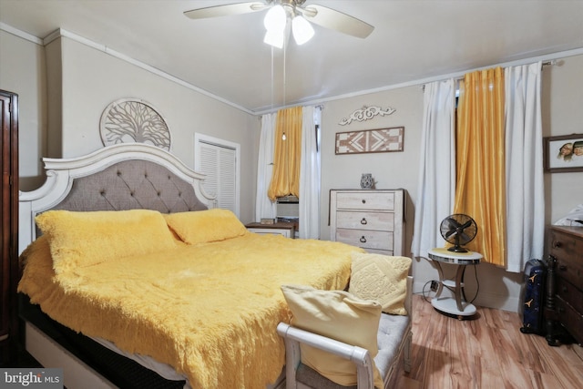 bedroom with crown molding, ceiling fan, and hardwood / wood-style flooring