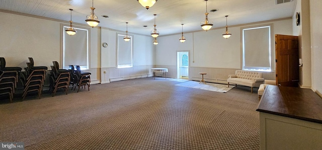 interior space featuring crown molding, dark colored carpet, and baseboard heating