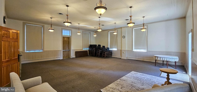 interior space with a baseboard heating unit and dark carpet