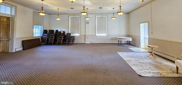 interior space featuring dark colored carpet, ornamental molding, and a baseboard radiator