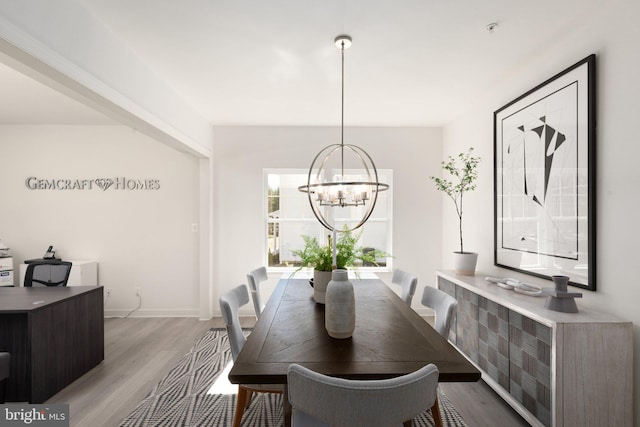 dining area featuring light hardwood / wood-style flooring and a chandelier