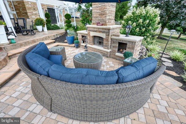 view of patio featuring an outdoor living space with a fireplace