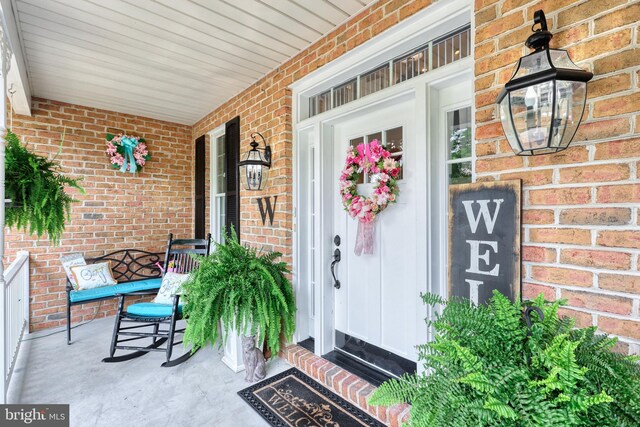 doorway to property with brick siding