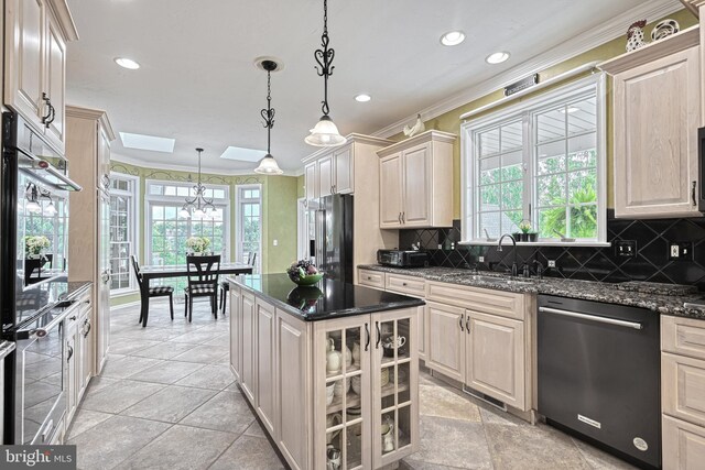 kitchen featuring stainless steel appliances, a sink, hanging light fixtures, glass insert cabinets, and crown molding