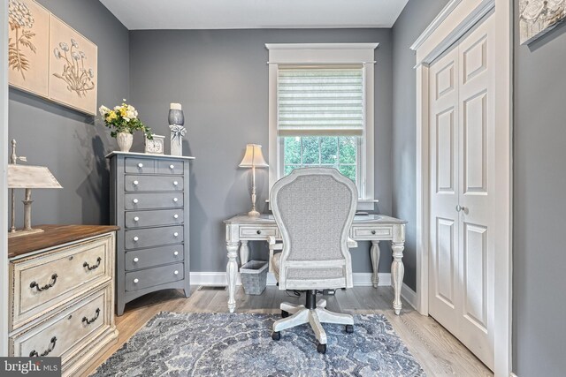 office featuring light wood-style flooring and baseboards