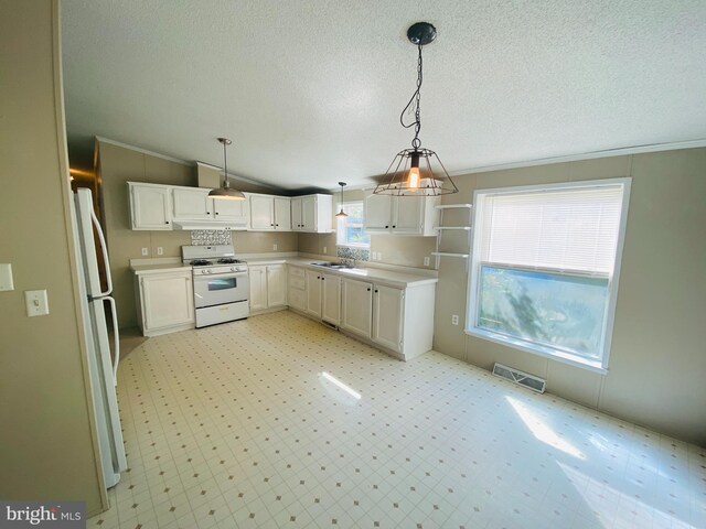 kitchen with vaulted ceiling, decorative light fixtures, white appliances, crown molding, and white cabinets