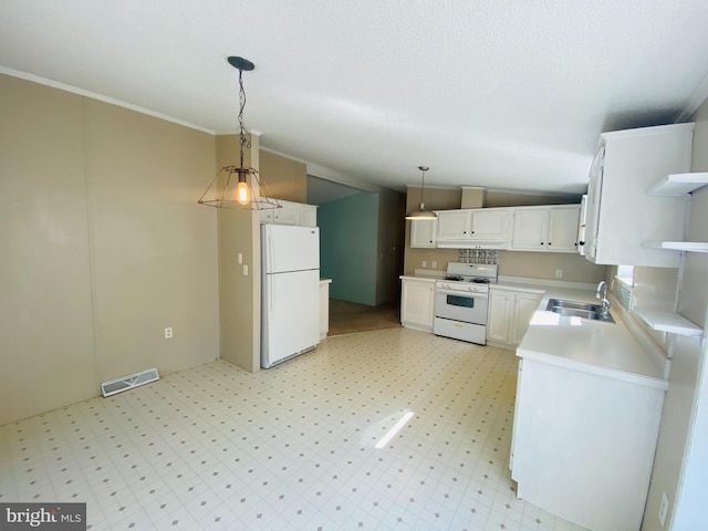 kitchen featuring white appliances, pendant lighting, sink, lofted ceiling, and white cabinets