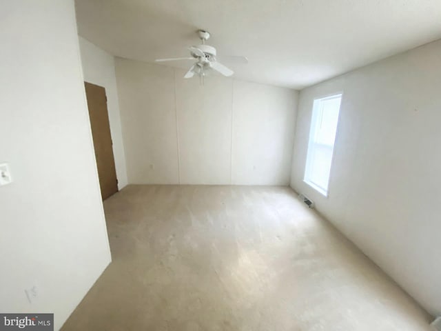 empty room with carpet flooring and ceiling fan