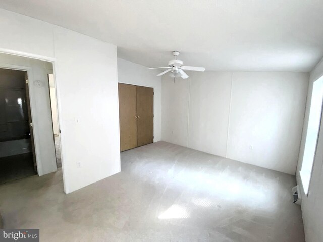 unfurnished bedroom with multiple windows and ceiling fan