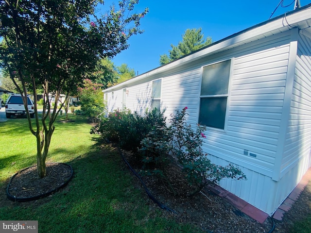 view of side of property with a yard